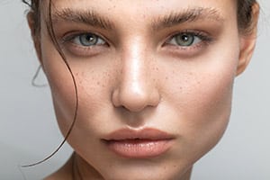 Close up studio shot of a beautiful woman with perfect skin