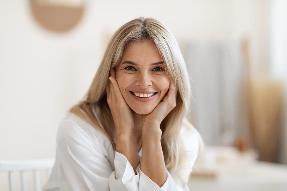 Beautiful middle aged woman smiling at camera, closeup portrait