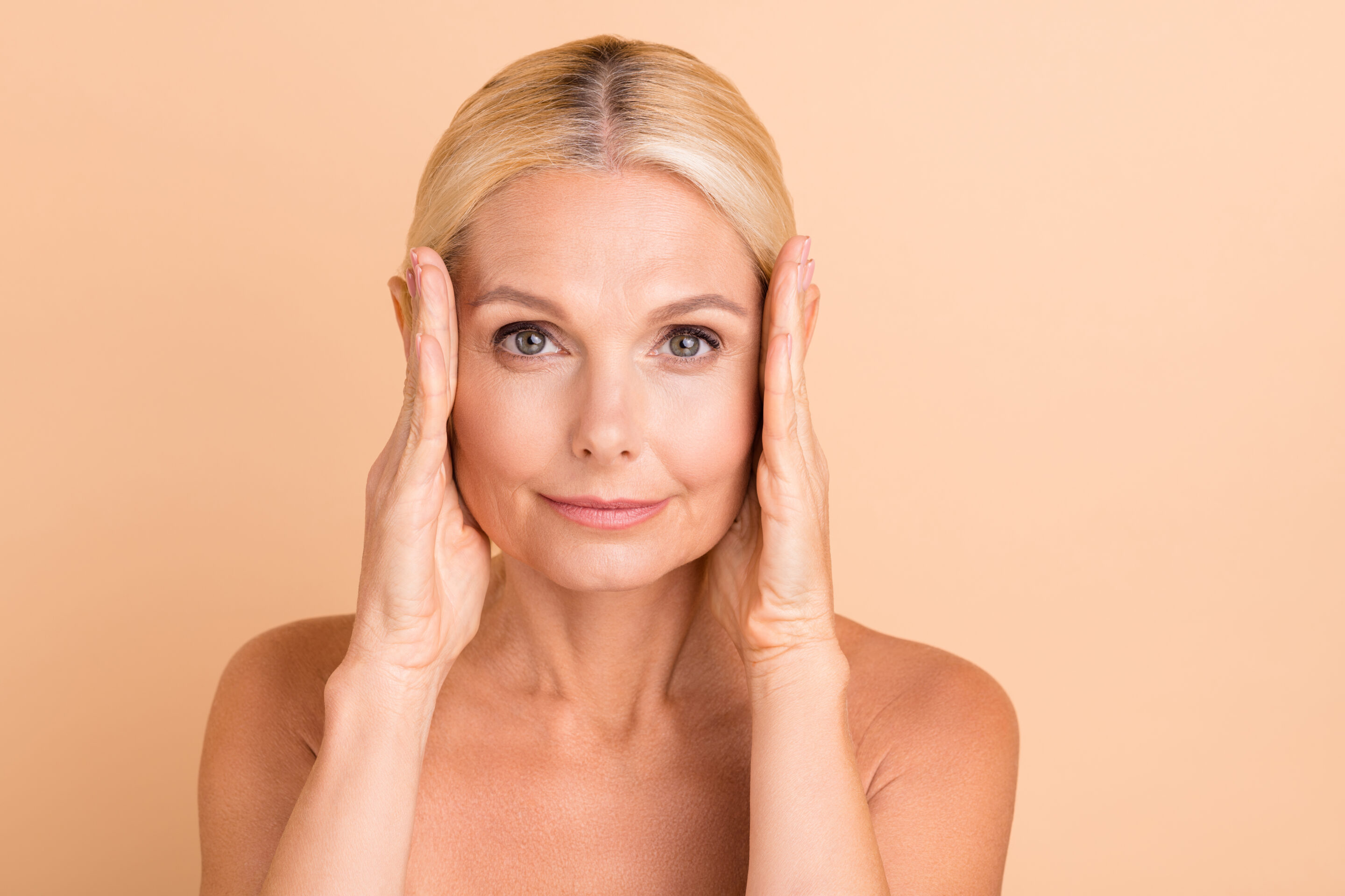 A Woman Holding Her Face After Mini Facelift